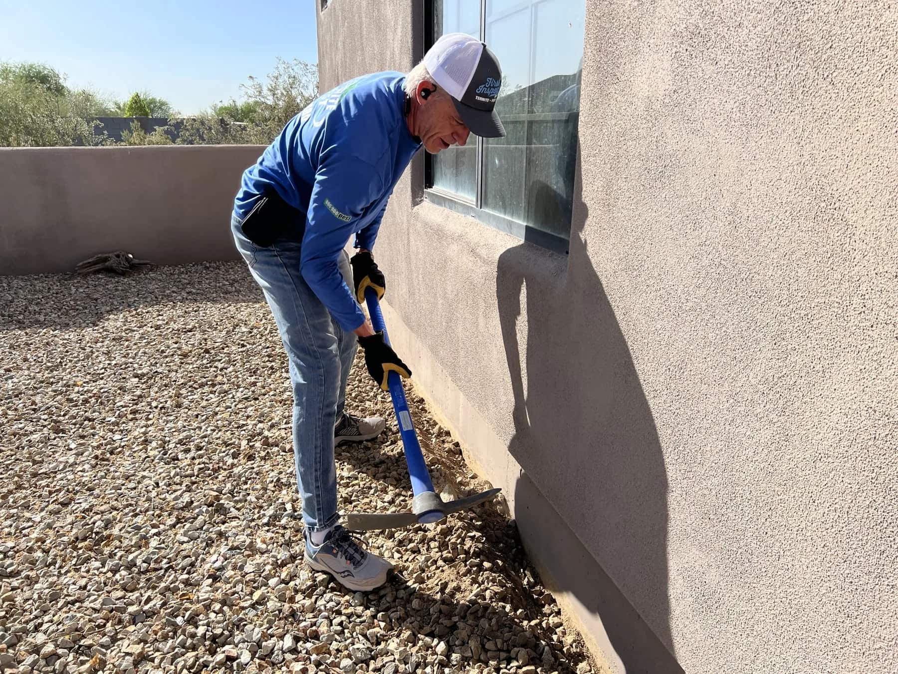 Stem wall and adjacent landscape rock at a Phoenix-area home, treated as part of the home-perimeter barrier